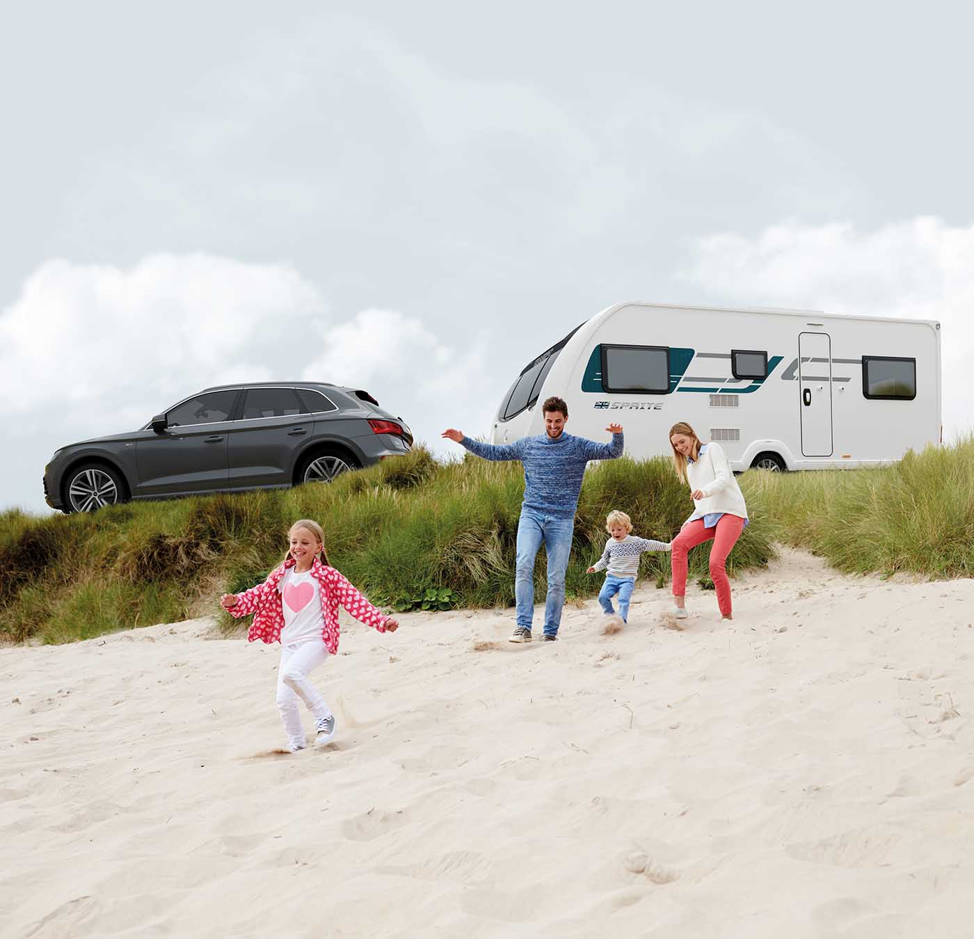 a family towing their caravan holiday on the beach