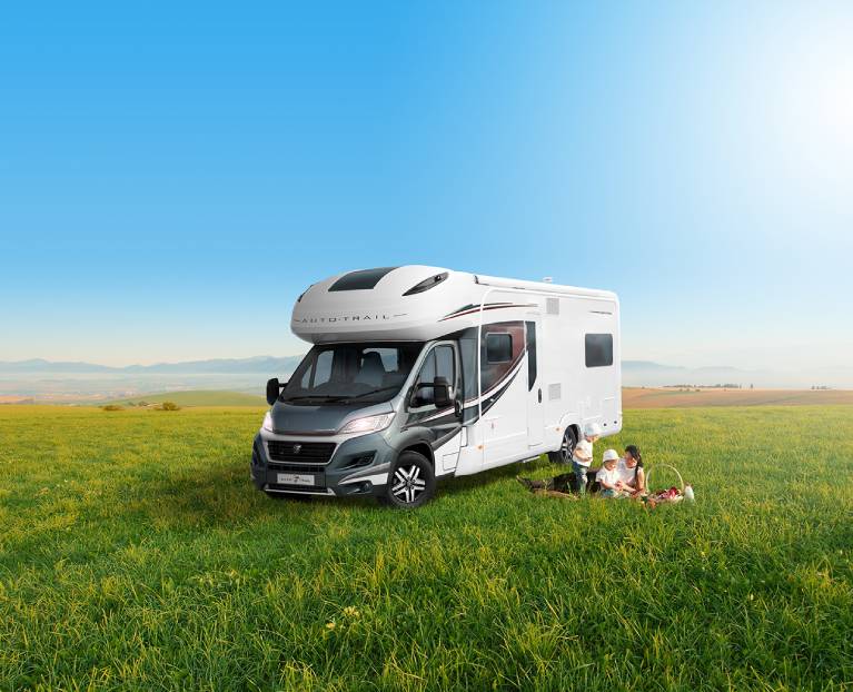 A family enjoying a motorhome holiday in a field