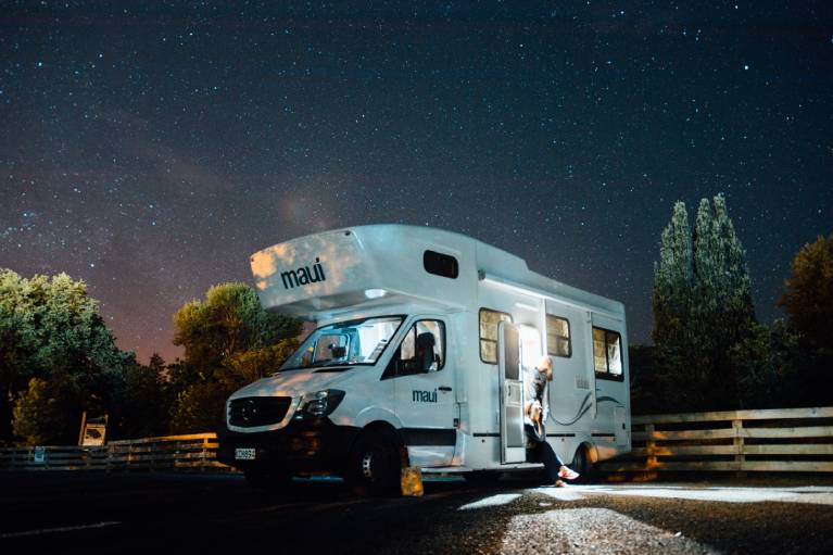 a couple using gadgets in their motorhome