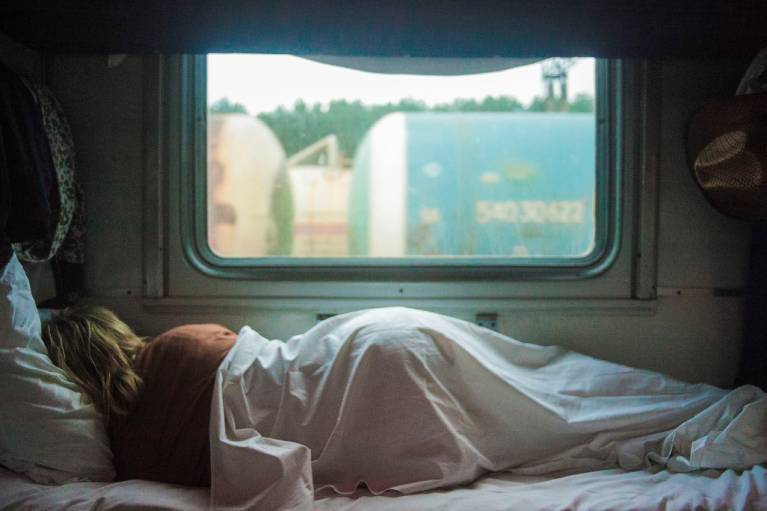 A women trying to get to sleep in a caravan